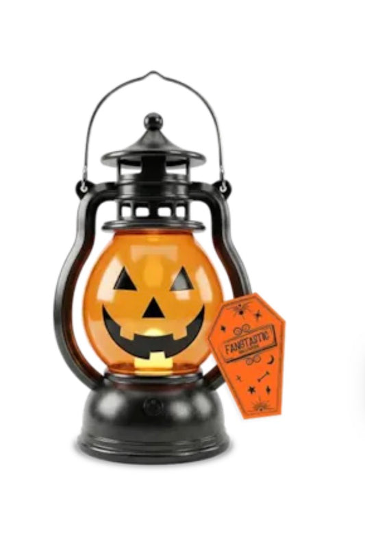 A black metal lantern-shaped Halloween decoration with an orange glowing jack-o'-lantern face and a small orange tag reading 'FANTASTIC!'.